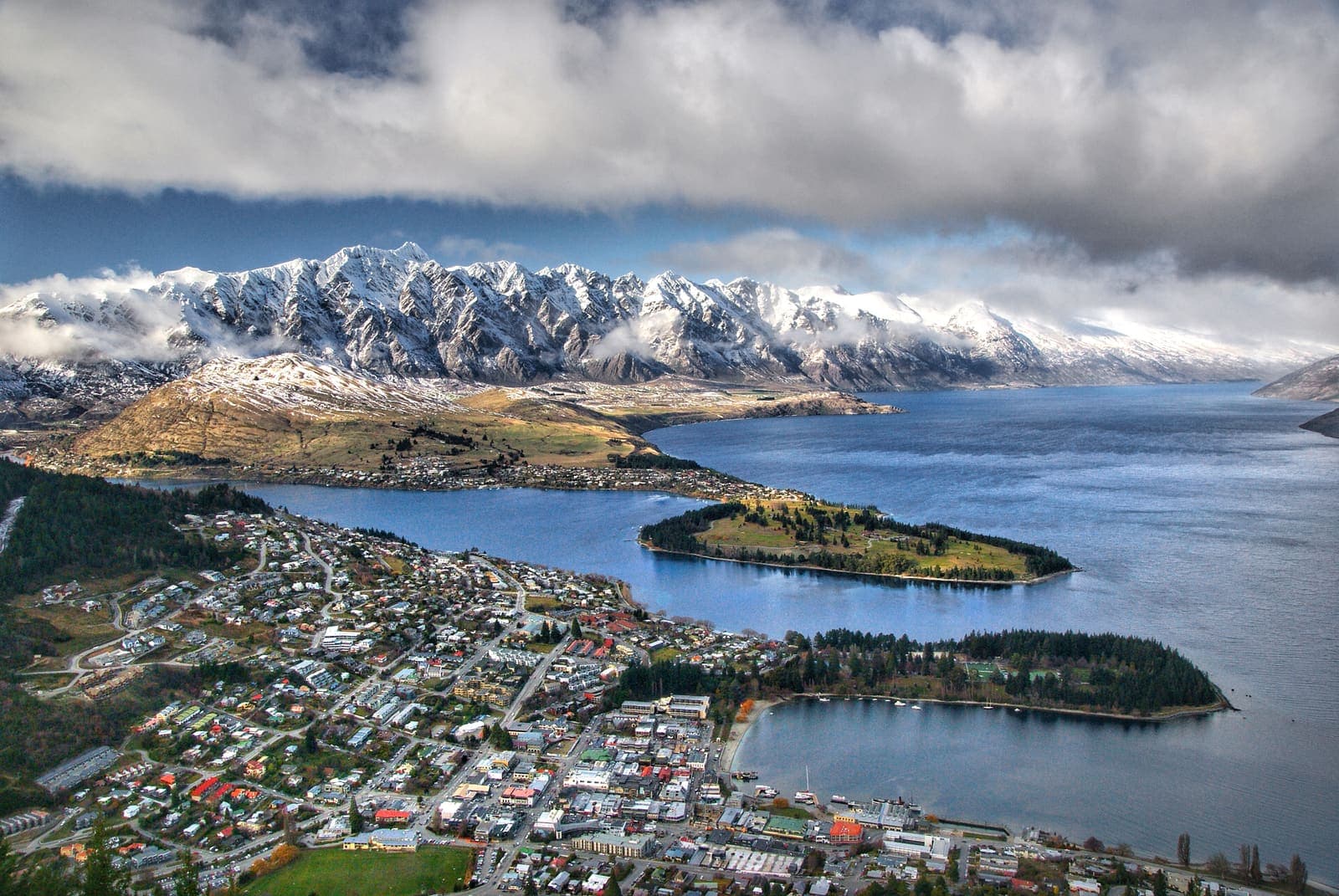 Queenstown and Lake Wakatipu seen from above, with The Remarkables range under snow